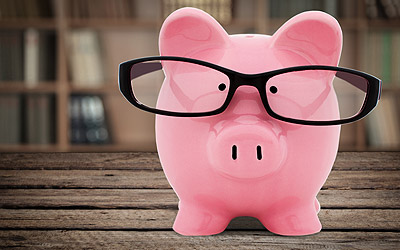 A piggy bank with glasses on