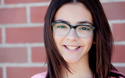 Girl smiling with glasses on