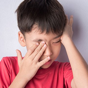 Closeup of child rubbing his eyes